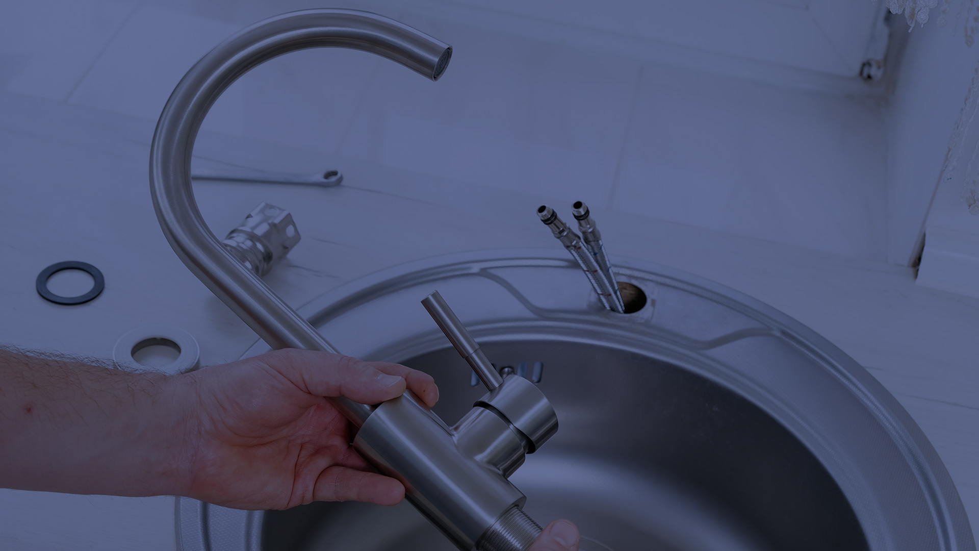 plumber installing a faucet on a kitchen lomita ca